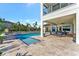 Stunning pool area with expansive patio and serene water views at 323 Hawk Talon Dr, Lithia, FL 33547