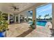 Spacious covered patio with pool and tranquil water views at 323 Hawk Talon Dr, Lithia, FL 33547