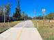 Paved bike path with speed limit sign and surrounding vegetation at 3276 Buckhorn Dr, Clearwater, FL 33761