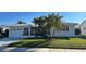 White single story home with palm trees and landscaped lawn at 3448 100Th N Ter, Pinellas Park, FL 33782