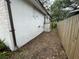 Exterior view of the side yard featuring a narrow walkway between the house and a wooden fence at 432 2Nd Ne Ave, Largo, FL 33770