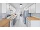 Bright kitchen with wood countertops, white cabinets, and stainless steel appliances at 4915 Bay Ne St # 130, St Petersburg, FL 33703
