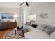 Living room with hardwood floors, sectional sofa, and a modern coffee table at 725 Caya Costa Ne Ct, St Petersburg, FL 33702