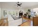 Living room with white sectional sofa, fireplace, and hardwood floors at 725 Caya Costa Ne Ct, St Petersburg, FL 33702