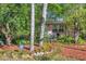 Pink house nestled amongst tropical foliage and palm trees at 8161 54Th N St, Pinellas Park, FL 33781