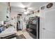 Galley kitchen with black appliances and light green cabinets at 8161 54Th N St, Pinellas Park, FL 33781