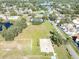 Aerial view showing tennis courts, a basketball court, and open green space at 9515 Citrus Glen Pl, Tampa, FL 33618