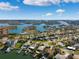 Wide aerial view of waterfront community with lush landscaping and numerous homes at 10244 Tarpon Dr, Treasure Island, FL 33706