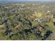 Aerial view of a large property with several houses and open spaces, showing a rural landscape at 11008 Browning Rd, Lithia, FL 33547