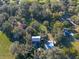Aerial view of a property with multiple houses, a pool, and lush greenery at 11008 Browning Rd, Lithia, FL 33547