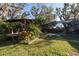 Private backyard with gazebo, lush landscaping, and screened-in pool at 11008 Browning Rd, Lithia, FL 33547