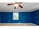 Bedroom with blue walls and ceiling fan at 11008 Browning Rd, Lithia, FL 33547