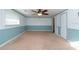 Bedroom with light blue wainscoting and ceiling fan at 11008 Browning Rd, Lithia, FL 33547