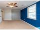 Bedroom with gray and blue walls and ceiling fan at 11008 Browning Rd, Lithia, FL 33547