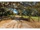 Driveway entrance with a gated entry and mature trees at 11008 Browning Rd, Lithia, FL 33547