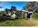 White shed with lush landscaping in the backyard at 11008 Browning Rd, Lithia, FL 33547