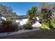 White shed with tropical landscaping at 11008 Browning Rd, Lithia, FL 33547