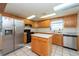 Kitchen with wood cabinets, stainless steel appliances and island at 11008 Browning Rd, Lithia, FL 33547