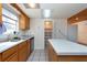 Kitchen features wood cabinets, double sink and island at 11008 Browning Rd, Lithia, FL 33547