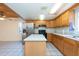 Kitchen with wood cabinets, tile floor and pantry at 11008 Browning Rd, Lithia, FL 33547