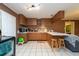 L-shaped kitchen with wood cabinets and breakfast bar at 11008 Browning Rd, Lithia, FL 33547