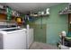Functional laundry room with washer, dryer, and storage shelves at 11008 Browning Rd, Lithia, FL 33547