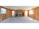 Spacious living room with wood walls and fireplace at 11008 Browning Rd, Lithia, FL 33547