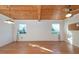 Living room with hardwood floors, wood ceilings and two windows at 11008 Browning Rd, Lithia, FL 33547