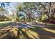 Large, partially shaded yard with a cement slab at 11008 Browning Rd, Lithia, FL 33547