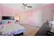 Bedroom with a full bed, ceiling fan, and pink walls at 11149 Golden Silence Dr, Riverview, FL 33579