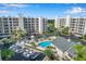 Aerial view showcases community with a pool and manicured landscaping at 1200 Country Club Dr # 3204, Largo, FL 33771