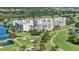 An aerial view of a condo community featuring golf courses, ponds, and lush greenery at 1200 Country Club Dr # 3204, Largo, FL 33771