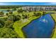Beautiful aerial view of the condo complex, lake with fountain, and lush landscaping at 1200 Country Club Dr # 3204, Largo, FL 33771