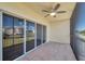 A screened condo balcony with a ceiling fan, tile floors, and views of the community at 1200 Country Club Dr # 3204, Largo, FL 33771