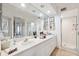 Double vanity bathroom with large mirror and shower at 1200 Country Club Dr # 3204, Largo, FL 33771