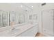 The bathroom features a double vanity, a large mirror, and a walk-in shower at 1200 Country Club Dr # 3204, Largo, FL 33771