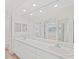 The bathroom features a double vanity, a large mirror, and a walk-in shower at 1200 Country Club Dr # 3204, Largo, FL 33771
