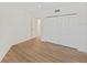 Bright bedroom with light wood flooring and white closet with bi-fold doors at 1200 Country Club Dr # 3204, Largo, FL 33771