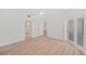 Bedroom with light-colored wood floors and white walls, plus access to bath and balcony at 1200 Country Club Dr # 3204, Largo, FL 33771