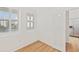Bright bedroom featuring hardwood floors, two windows with plantation shutters, and ample closet space at 1200 Country Club Dr # 3204, Largo, FL 33771