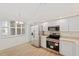 Bright kitchen with white cabinetry, stainless steel appliances, and eat in space at 1200 Country Club Dr # 3204, Largo, FL 33771