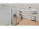 The kitchen features stainless steel appliances, white cabinetry, and an eat-in bar at 1200 Country Club Dr # 3204, Largo, FL 33771