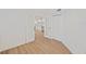 Open-concept living room with wood floors leading into kitchen with white cabinetry at 1200 Country Club Dr # 3204, Largo, FL 33771