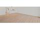 Spacious living room with wood-look flooring and white walls, showcasing an open layout at 1200 Country Club Dr # 3204, Largo, FL 33771