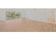 Bright living room featuring hardwood floors, a ceiling fan, and sliding glass doors to the balcony at 1200 Country Club Dr # 3204, Largo, FL 33771