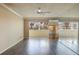 Open living room with hardwood floors and access to balcony at 12000 Capri S Cir # 16, Treasure Island, FL 33706