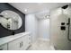 Stylish bathroom featuring vessel sink, circular mirror, and shower with niche at 1400 Gulf Blvd # 801, Clearwater Beach, FL 33767