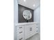 Elegant bathroom with a vanity, quartz countertop and large round mirror at 1400 Gulf Blvd # 801, Clearwater Beach, FL 33767