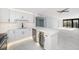 Modern white kitchen with stainless steel appliances and quartz countertops at 1400 Gulf Blvd # 801, Clearwater Beach, FL 33767