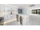 Open kitchen featuring white cabinets, marble counters, wine cooler, and opening to living space at 1400 Gulf Blvd # 801, Clearwater Beach, FL 33767